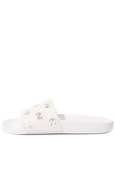 On these white rubber slippers, the diamond-shaped pattern in the form of GG monograms, plays not only a decorative, but also a functional role. An openwork motif, made in the technique of perforations, conducts heat well from the legs. This comfort is also supported by an orthopedic insole that reduces the load on the joints.Composition: Rubber 100%Lining: Rubber 100%Sole: Rubber 100%Made in Italy White Open Toe Slippers With Rubber Sole, Designer White Sandals With Rubber Sole, Classic White Slip-on Sandals, Classic White Flat Sandals, Classic White Slides With Round Toe, Luxury White Synthetic Sandals, White Studded Open Toe Sandals, White Elegant Synthetic Slippers, Elegant White Flat Slides