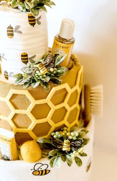 a three tiered cake decorated with bees and honeycombs