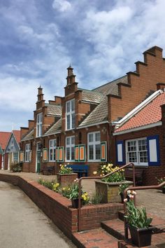 a row of brick houses with blue windows