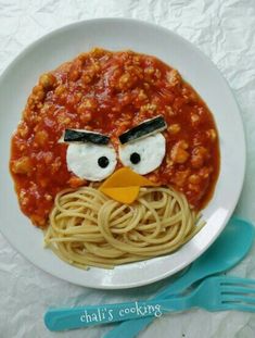 a plate with spaghetti and an angry bird face on it