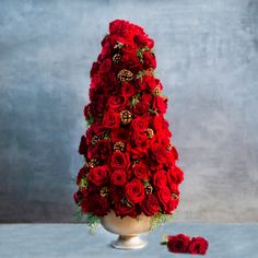 a vase filled with red roses on top of a table