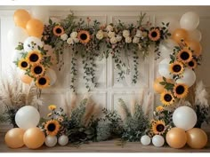 sunflowers and balloons are arranged on the wall