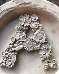 the letters are made out of clay and decorated with flowers