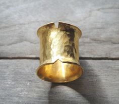 This is a handmade ring made from a bronze sheet then soldered and hammered and finally gold plated 24ct MATERIALS: gold plated bronze DIMENSION:2 cm height(0,8 inch approximately) I can make this ring to your size.You can find your size by looking here:http://www.bluenile.com/pdf/bluenile_ringsizer_copyright2008.pdf Every ring is handmade and unique. You will receive a very similar to the photo but not identical. I will pack your ring in a gift box as in my last photo.See my shop policies here: Artisan Gold Ring With Hammered Detail, Artisan Gold Hammered Rings, Artisan Hammered Gold Rings, Unique Gold Hammered Wide Band Ring, Hand Forged Gold Wide Band Ring, Unique Hammered Gold Wide Band Ring, Hand Forged Gold Wide Band Ring Gift, Hammered Brass Wide Band Jewelry, Architectural Rings