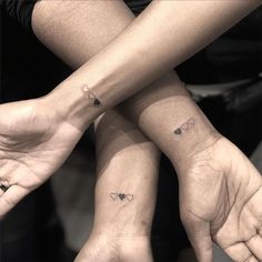 two people with matching tattoos on their hands