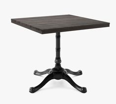 a square wooden table with an iron base