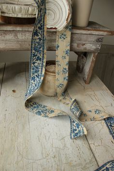 a blue and white ribbon sitting on top of a wooden bench