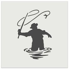 a man standing in the water holding a fishing pole