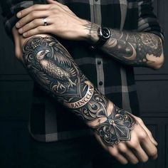 a man with tattoos on his arms and arm is wearing a black checkered shirt