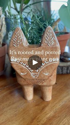 a wooden cat planter sitting on top of a table