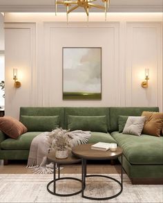 a living room with a green couch and coffee table in front of a painting on the wall