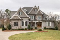 a large gray house with lots of windows