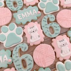 decorated cookies are arranged on a wooden table