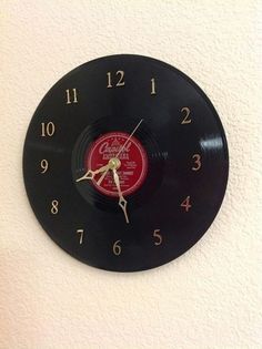 a black and red clock on the wall