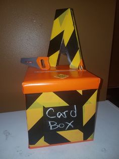 an orange and black box with a sign that says card box