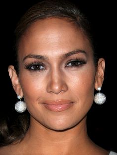 a close up of a person wearing earrings