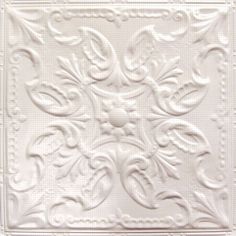 a white tile with an intricate design on it