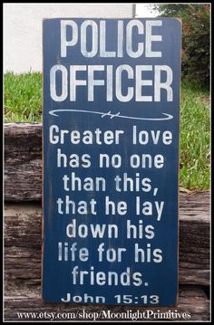 a wooden sign that says police officer greater love has no one than he lay down his life for his friends