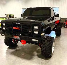 a large black truck parked in a garage