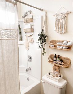 a white toilet sitting next to a bath tub in a bathroom under a shower curtain