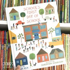 a person holding up a book about school's first day of school in front of a black background