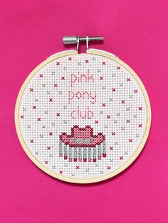 a pink pony club cross stitch pattern on a hoop