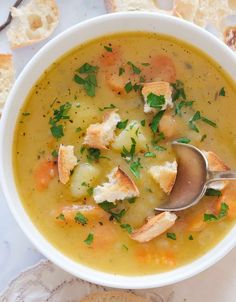 a white bowl filled with soup and bread