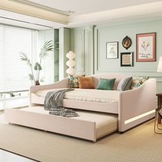 a living room filled with furniture next to a window covered in windowsills and framed pictures