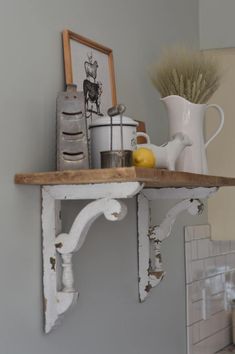 an old shelf with some items on it and a potted plant in the corner