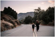 two people walking down the road holding hands