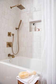 a bathroom with a tub and shower head