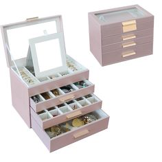 two pink drawers with gold and silver jewelry in them next to each other on a white background