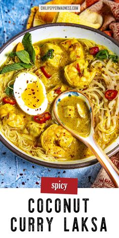 a bowl of coconut curry laksa with an egg on top and the title spicy coconut curry laksa