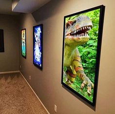 an empty room with three pictures on the wall and two people walking down the hall