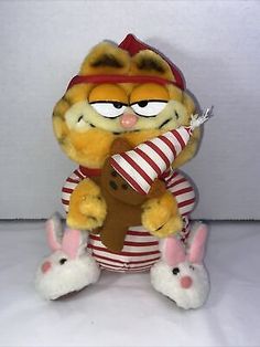 garfield the cat stuffed animal holding a candy bar