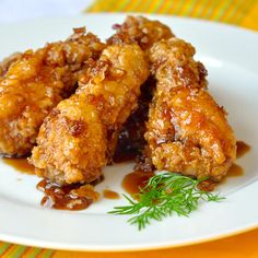 two fried chicken wings on a white plate