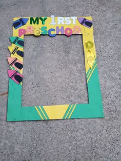 a cardboard frame with the words my first pre school cut out in it on concrete