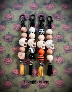 several different types of beads with skulls and tassels attached to each bead