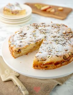 a white plate topped with a cake covered in powdered sugar