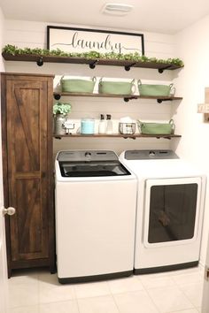 a white washer and dryer sitting next to each other in a laundry room