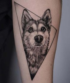 a black and white tattoo with a dog's face in the center of it