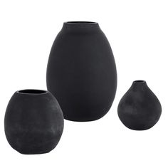 three black vases sitting next to each other