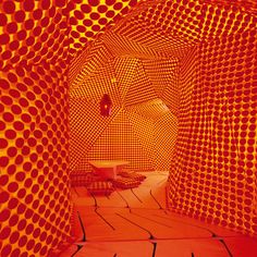 a room with orange and red circles on the walls, as if it were an art installation