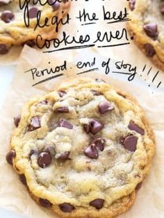 three chocolate chip cookies sitting on top of each other next to a piece of parchment paper