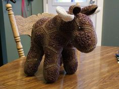 a stuffed animal sitting on top of a wooden table