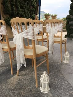 the chairs are decorated with lace and bows