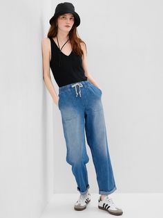 Fit: Pull-on jeans with an elastic waistband & easy, relaxed leg.  Fabric: 95% Cotton, 5% Recycled Cotton.  Stretch: No Stretch Jeans.  Authentic denim that gets better with every wear.  Made to wear all day & break in over time. ​ Rise: Mid Rise Jeans.  Look: A four-pocket jean in a medium indigo wash with fading.  Raw, cuffed hem can be unrolled.  Details: Elasticized waist with drawcords & four-pocket styling.  Responsibly Made: This pair of jeans is part of our water-saving Washwell program. Pull On Jeans, Water Saving, Jeans Mom, Break In, Gap Jeans, Mid Rise Jeans, Pocket Jeans, High Rise Jeans, Stretch Jeans