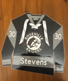 the back of a black and white jacket that says roseville riders with an eagle on it