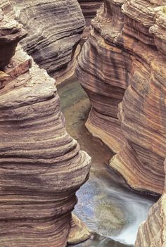 the water is running through the narrow canyon