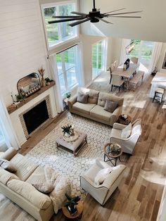 an aerial view of a living room with couches, chairs and a fire place